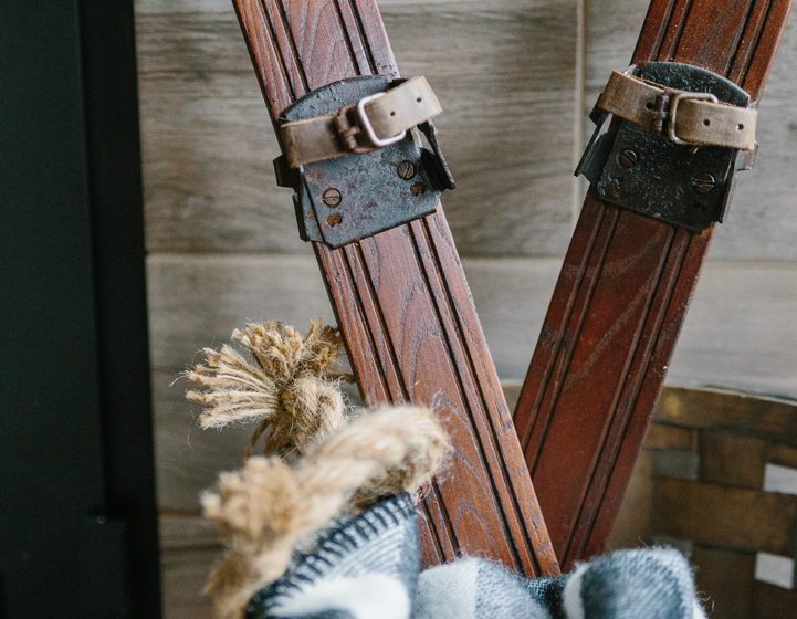 Antique Skis in a Basket With a Plaid Blanket