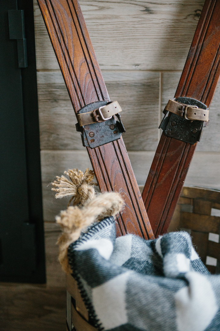 Antique Skis in a Basket With a Plaid Blanket