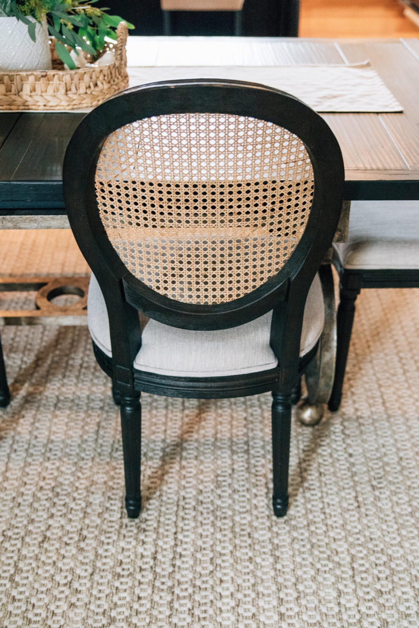 Black cane back dining chair closeup - Interior Impressions
